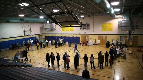 Voters line up to cast their ballots in the gym at Northside Elementary School in Midway, Kentucky.