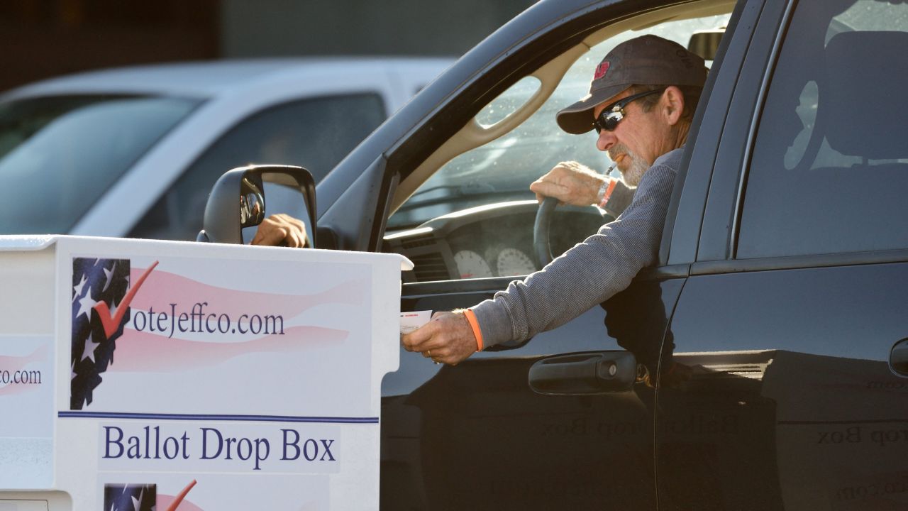 A voter drops his election ballot at one of many drop boxes in Arvada, Colorado, a Denver suburb.