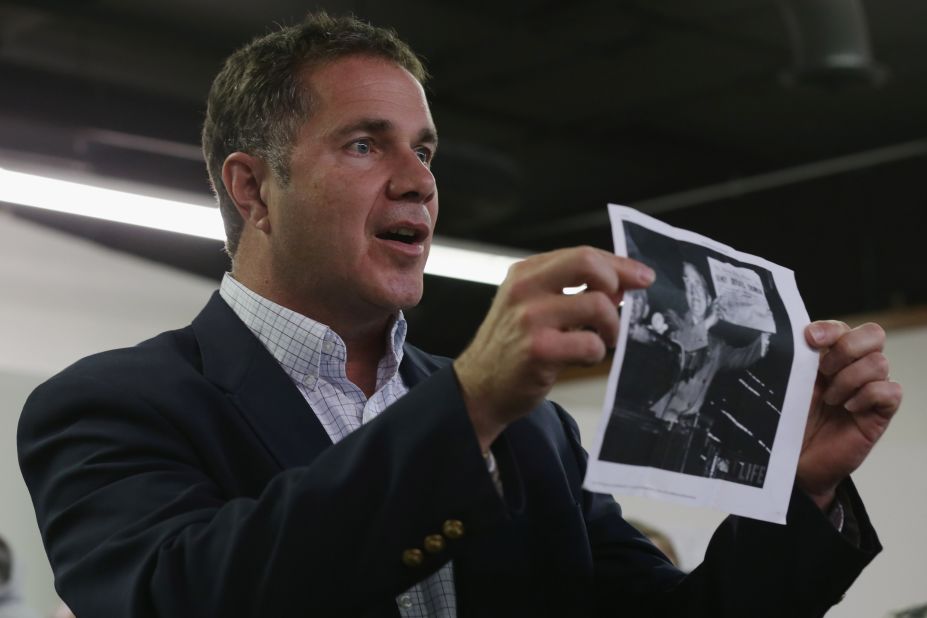 While encouraging volunteers not to give up Monday, November 3, Braley holds up a photo of the famous "Dewey Defeats Truman" headline from 1948. Braley was visiting a Democratic headquarters in Cedar Rapids, Iowa.