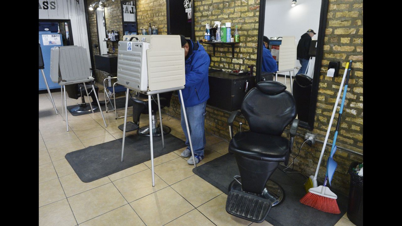 Voters cast their ballots at First Class Barber Shop in Chicago.