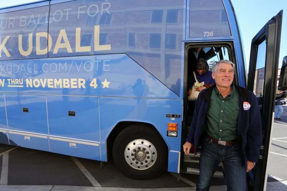 Udall exits his campaign bus during an Election Day visit to the University of Colorado in Boulder, Colorado.