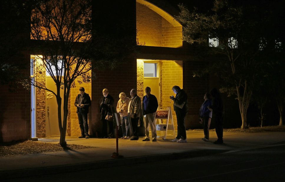 A handful of people wait in line before polls open November 4  at Elizabeth Lane Elementary School in Matthews.