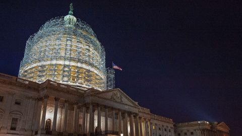 The US Capitol dome is cocooned in scaffolding on October 28, 2014 in Washington, DC as it undergoes its first comprehensive repairs in more than half a century a century. The two-year, USD 60 million project is aimed at repairing nearly 1,300 cracks that have emerged in the nine-million-pound (4.1-million-kilogram) cast iron dome, according to the Architect of the Capitol (AOC) office. Construction on the dome began in 1855. Work symbolically continued through the US Civil War and the structure was eventually completed in 1866. AFP Photo/Paul J. Richards (Photo credit should read )