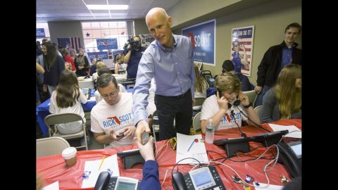 Scott stops by a Republican call center to rally campaign workers on November 4 in Fort Myers, Florida.