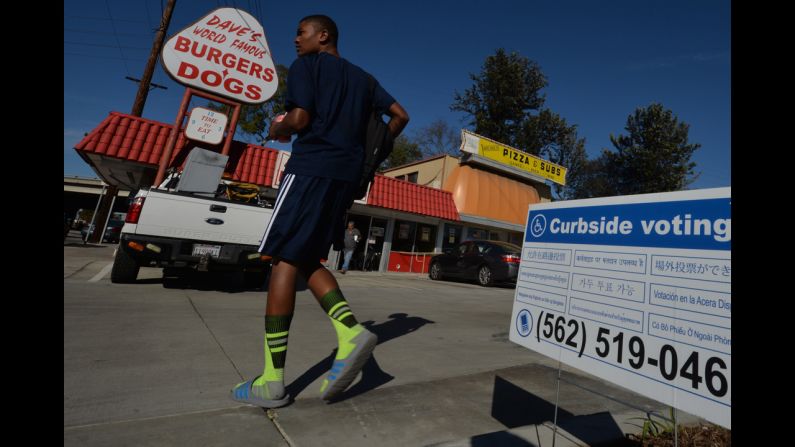 A man arrives to vote at the Avenue 3 Pizza shop in Long Beach, California. 