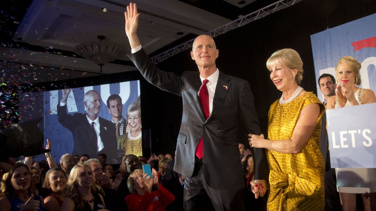 Florida Gov. Rick Scott waves to the crowd as he and his wife, Ann, take the stage at a victory party in Bonita Spring, Florida, after defeating Democratic challenger Charlie Crist on Tuesday, November 4.