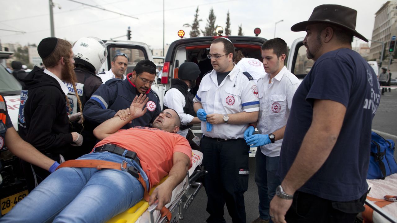 JERUSALEM, ISRAEL - NOVEMBER 05:  Israeli rescue workers and paramedics carry an injured man to an ambulance after a Palestinian man, Ibrahim al-Akri, was shot by Israeli police officers after he drove into a crowd of people on November 5, 2014 in Jerusalem, Israel. One person was killed and at least 13 people were wounded during the suspected terror attack near East Jerusalem on Wednesday.  (Photo by Lior Mizrahi/Getty Images)