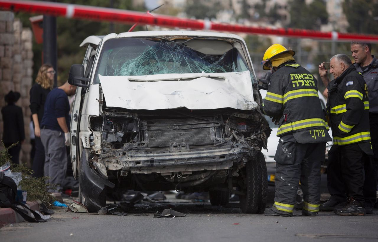Israeli firefighters inspect the scene of the attack. Police identified the driver as a member of the militant Islamic group Hamas.