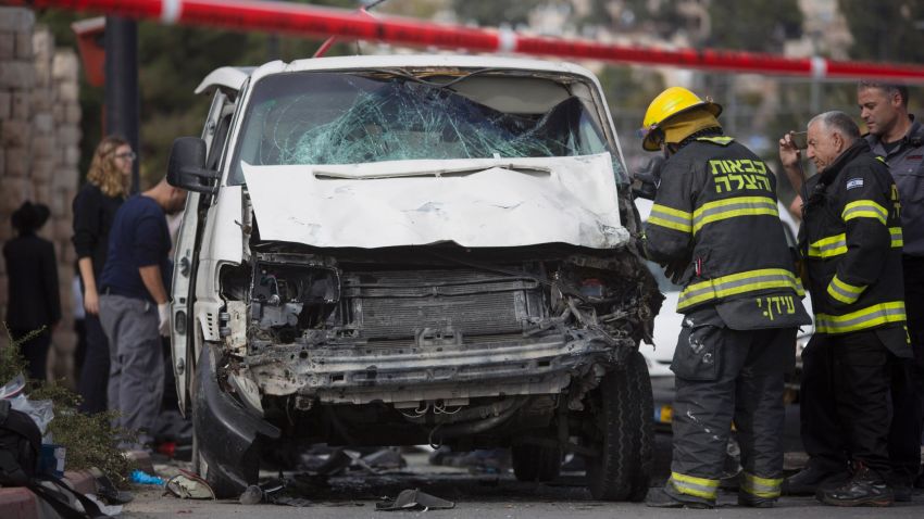 Israeli fire fighters inspect the scene of an attack in Jerusalem, Wednesday, Nov. 5, 2014. A Palestinian man rammed his car into a crowded train platform in east Jerusalem on Wednesday and then attacked people with an iron bar, killing one person and injuring 13 in what authorities called a terror attack before he was shot dead by the police. The militant Islamic group Hamas took responsibility for the attack. (AP Photo/Sebastian Scheiner)