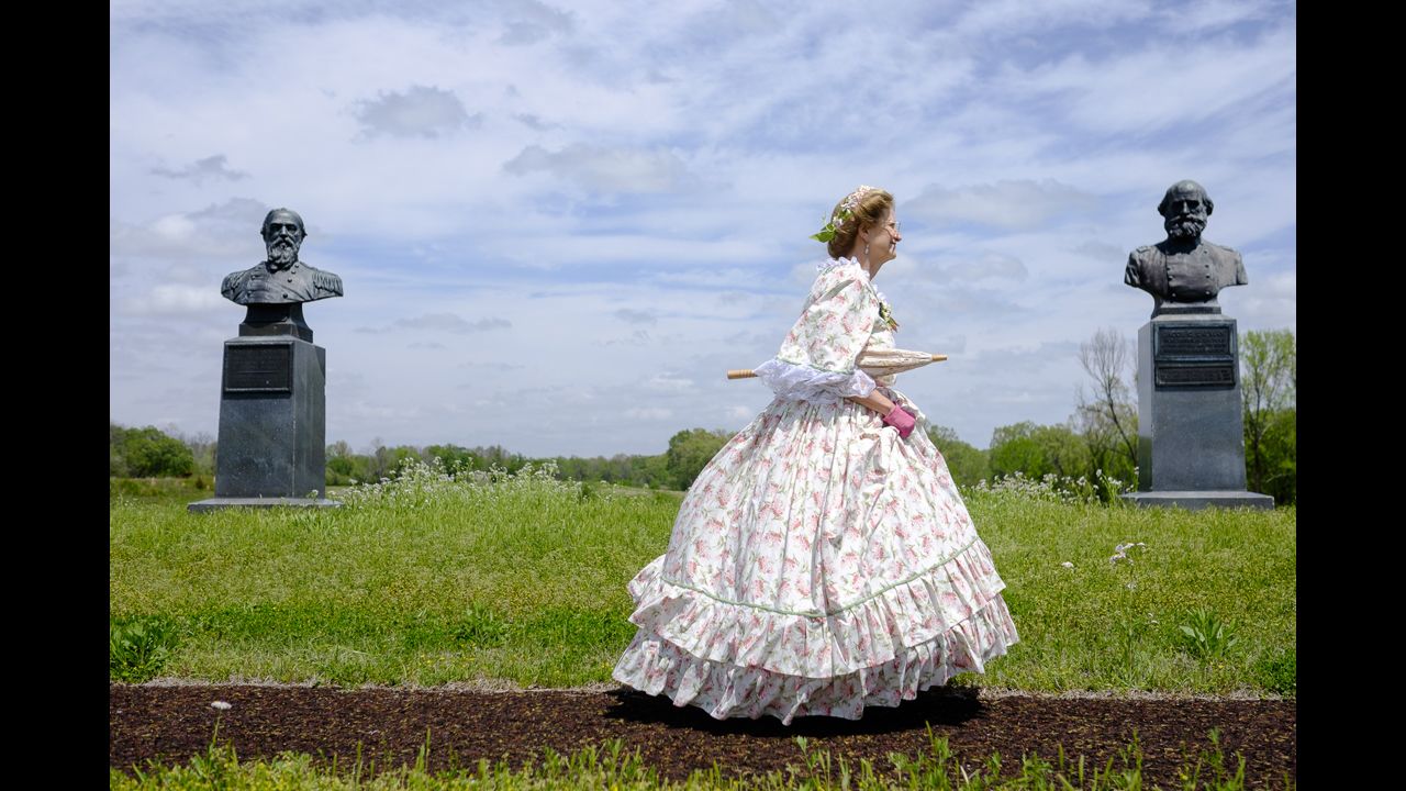 A woman dressed as Mary Todd Lincoln passes by a memorial at Vicksburg Military Park in Vicksburg, Mississippi.