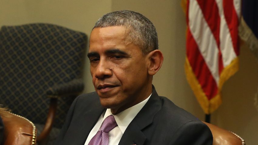 US President Barack Obama (C) is flanked by HHS Secretary Sylvia Mathews Burwell (L) and National Security Advisor Susan Rice, while meeting with his national security and public health teams in the Roosevelt Room at the White House, November 4, 2014 in Washington, DC.