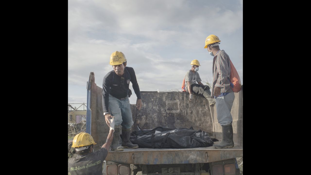 A month after the typhoon, bodies were still being found in the rubble. Every day, trucks arrived with new body bags at the improvised burial site by the church in the coastal village of Palo. Palo, December 2013.