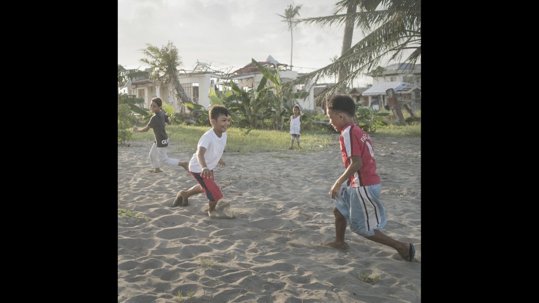 "This is my favorite place. There is a sense of freedom here, where my family can live and be happy and proud. After the typhoon we were not allowed to play outside because of all the dangerous waste. But now we can play on the beach again. We play 'Tumbalata,' a game where two teams compete by hitting soda bottles with their flip-flops in the sand," says Jednel. After six months, most of the rubble had been cleared by hand by community members. Tanauan, May 2014.