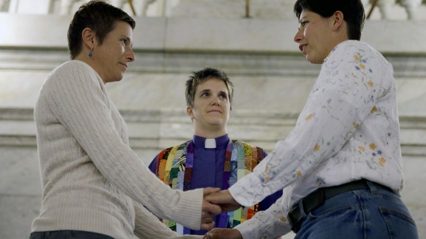 April Dawn Breeden, left, and her long-time partner Crystal Peairs, right, are married by Rev. Katie Hotze-Wilton at City Hall in St. Louis on Wednesday, November 5.