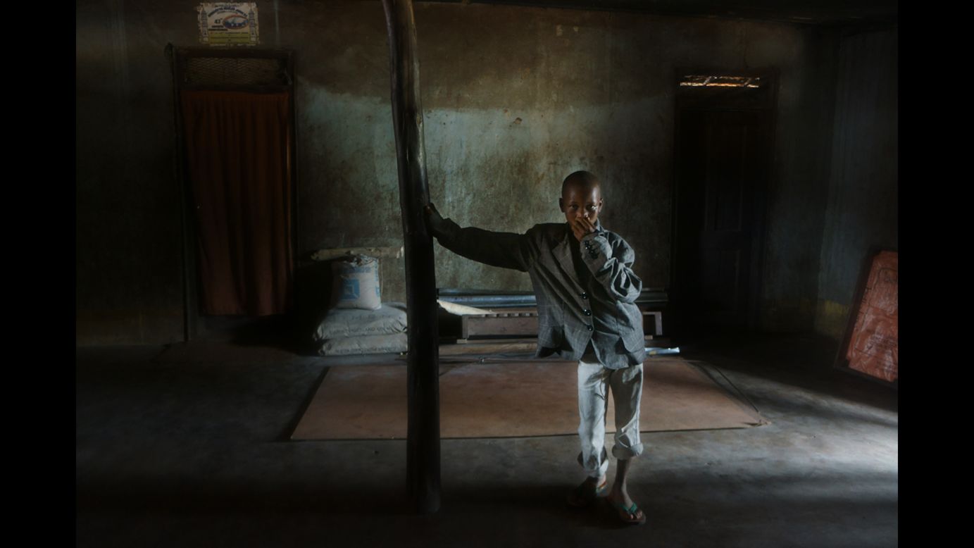 A boy leans against a structure in the Zimmi Village. In this village at least two people have died of Ebola. (Luigi Baldelli/ECHO)