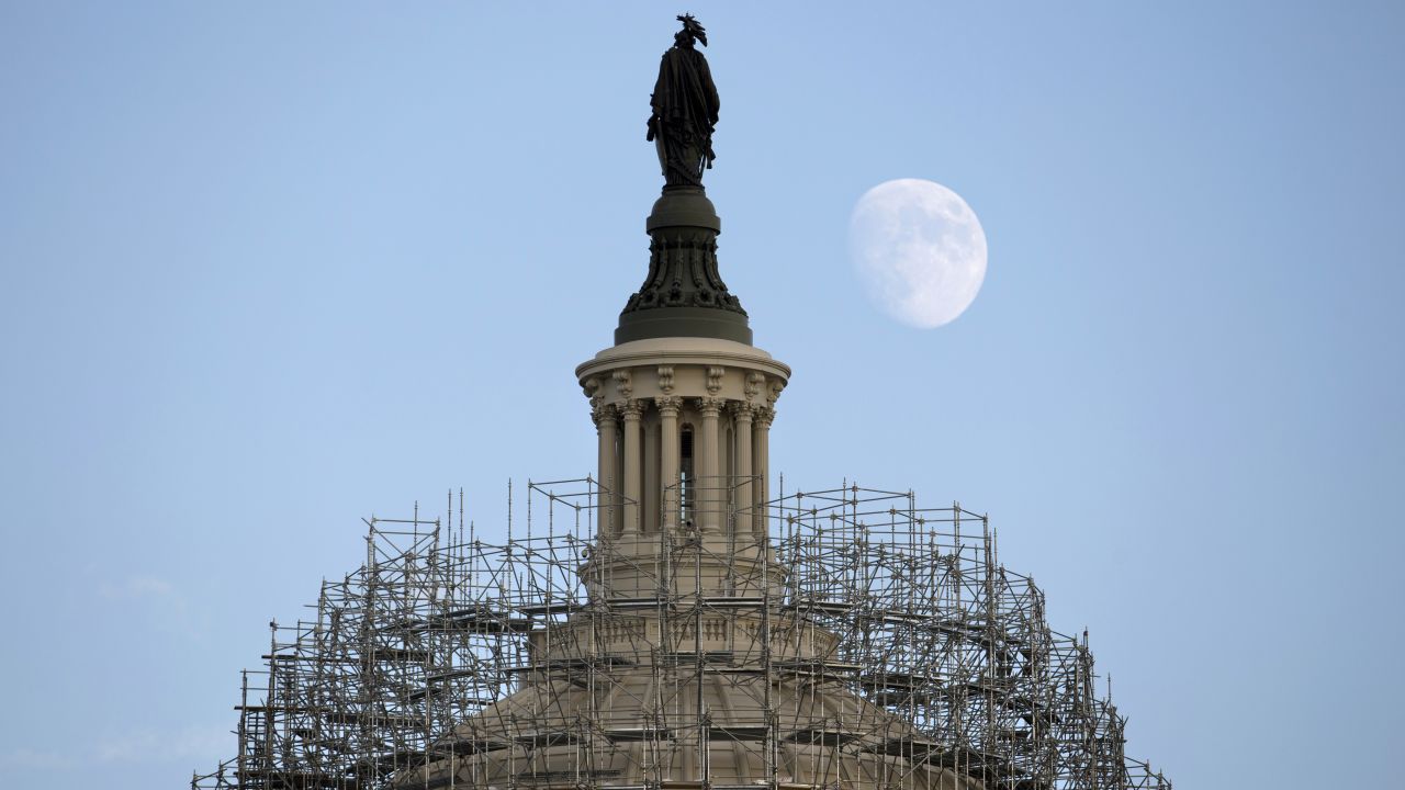 The moon rises over the Capitol dome in Washington on Monday, November 3. The scaffolding is part of a repair project to fix cracks, leaks and corrosion in the cast-iron structure.