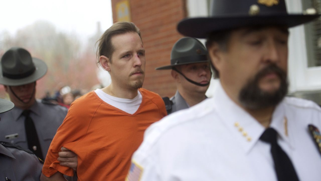 Eric Matthew Frein exits the Pike County Courthouse after his arraignment in Milford, Pennsylvania, on Friday, October 31. Frein was captured after a seven-week manhunt and held with the handcuffs of a Pennsylvania state trooper he is accused of killing.