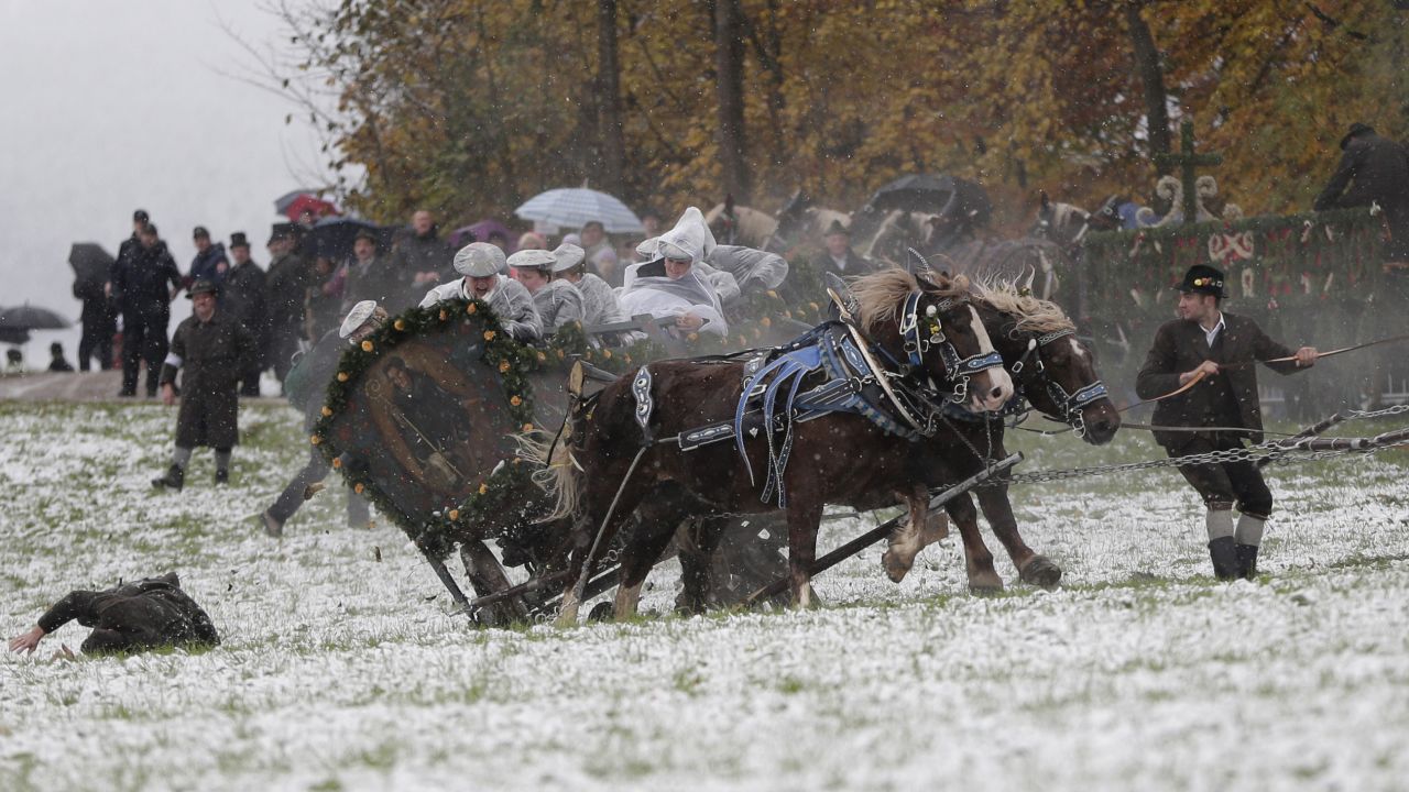 A man falls off a carriage after the horses bolted during the traditional Leonhardi pilgrimage in Bad Toelz, southern Germany, on Thursday, November 6. The annual pilgrimage honors St. Leonhard, patron saint of the highland farmers for horses and livestock.