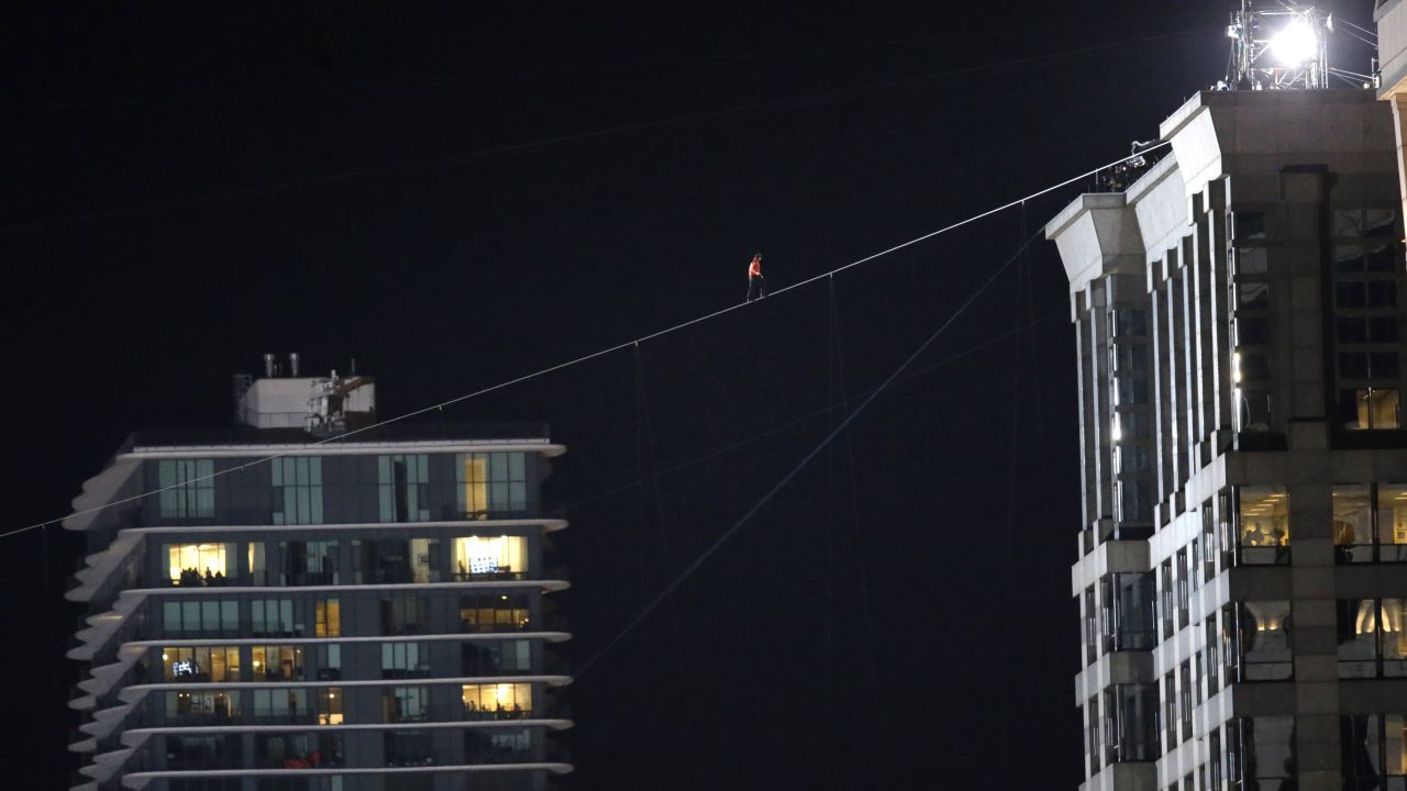 Daredevil Nik Wallenda makes his tightrope walk uphill at a 19-degree angle from the Marina City west tower across the Chicago River to the top of the Leo Burnett Building in Chicago on Sunday, November 2.
