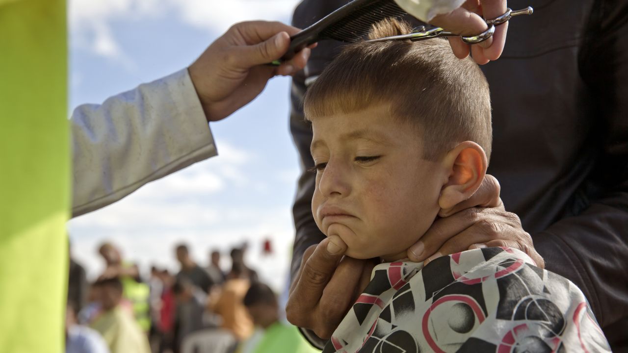 A Syrian Kurdish child from the Kobani area has his hair cut by a volunteer at a refugee camp in Suruc, near the Turkey-Syria border, on Sunday, November 2. ISIS militants have been advancing in Iraq and Syria as they seek to create an Islamic caliphate.