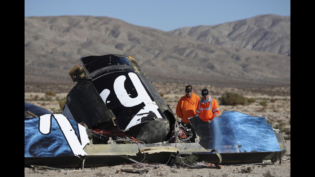 Sheriffs' deputies look at wreckage from the crash of Virgin Galactic's SpaceShipTwo near Cantil, California, on Sunday, November 2. The accident killed co-pilot Michael Tyner Alsbury and injured co-pilot Peter Siebold, who managed to parachute to the ground.