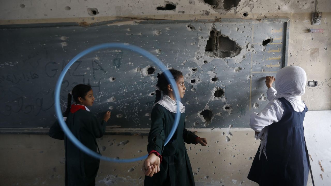 Palestinian girls play inside their school in Gaza on Wednesday, November 5. The school was damaged during the conflict between Israel and Hamas last summer.