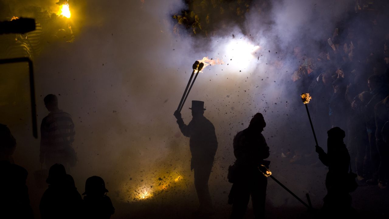 A participant in costume holds a torch as bonfire societies parade through the streets of Lewes in Sussex, England, on Wednesday, November 5, during the traditional Bonfire Night celebrations.  The celebrations are related to the ancient festival of Samhain, the Celtic New Year.