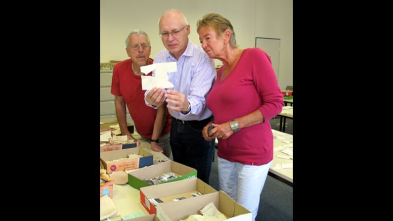 Frunder looks at fragments of paper which revealed the identity of the person who betrayed him.