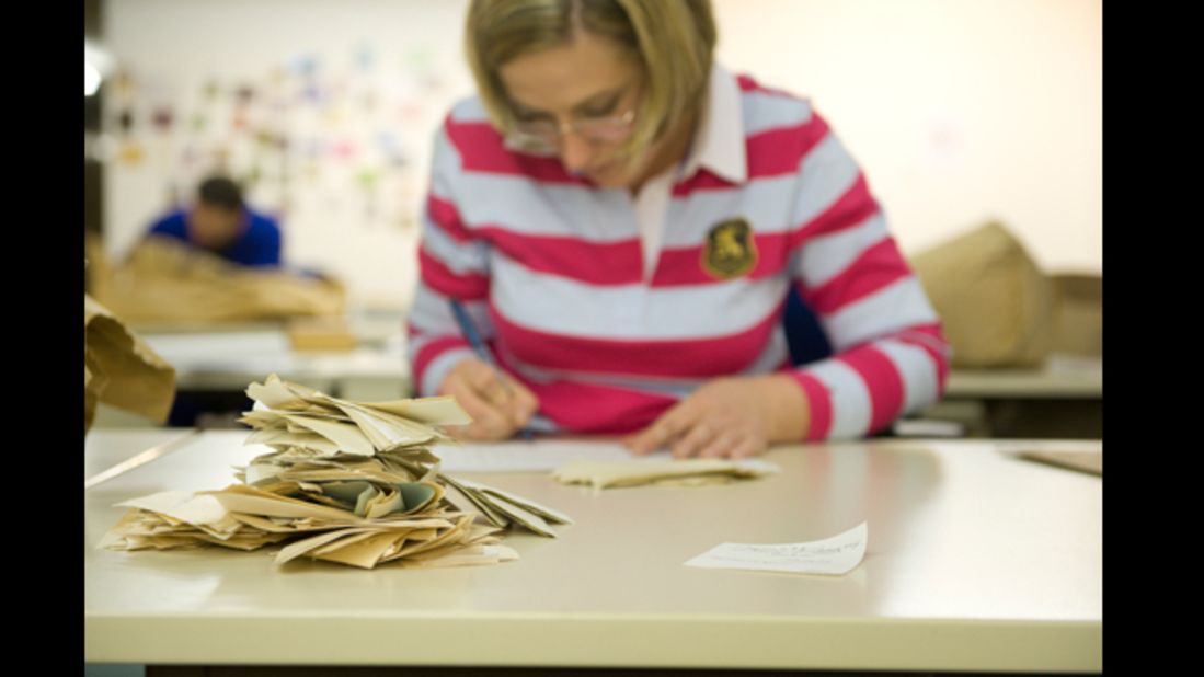 A Stasi Records Agency employee pieces together some of the 600 million fragments of paper.