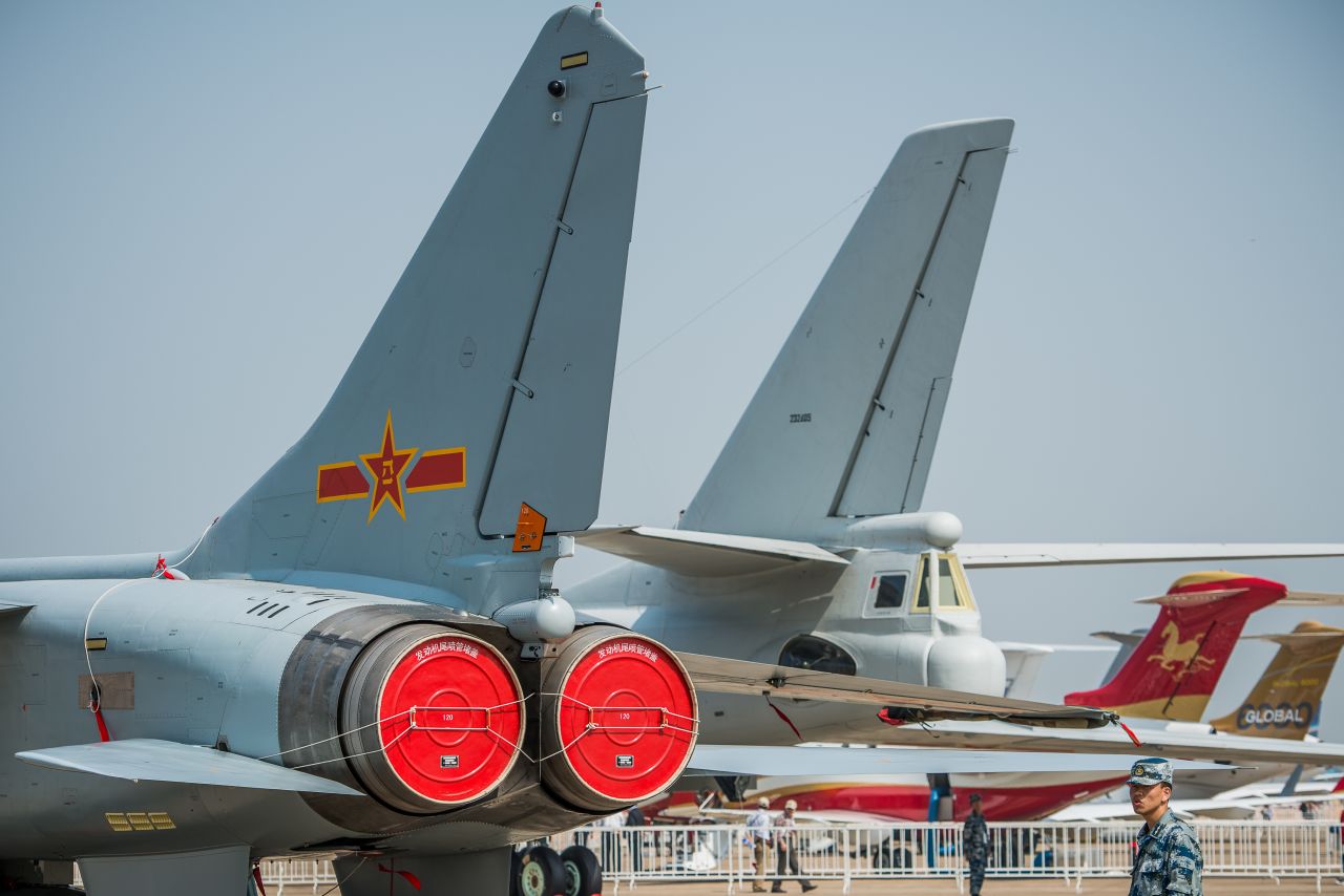 A soldier stands guard next to planes displayed during the airshow on November 13, 2012. While most Western aircraft manufacturers stay aloft thanks to sales of commercial jets, China's state-funded aerospace industry is heavily geared toward the military.
