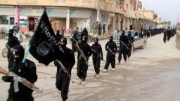 This undated file image posted on a militant website on Jan. 14, 2014, which has been verified and is consistent with other AP reporting, shows fighters from the al-Qaida linked Islamic State of Iraq and the Levant (ISIL) marching in Raqqa, Syria.