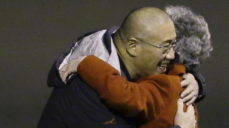 Kenneth Bae, who had been held in North Korea since 2012, greets his mother Myunghee Bae after arriving, Saturday, Nov. 8, 2014, at Joint Base Lewis-McChord, Washington, after Bae and Matthew Todd Miller, who was held in North Korea since April, 2014, were freed during a top-secret mission by James Clapper, U.S. director of national intelligence. 