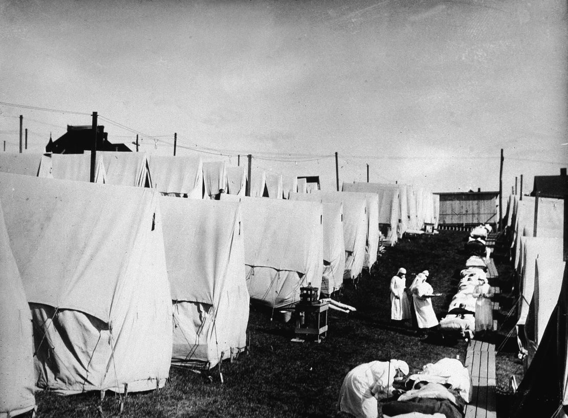 Nurses In Lawrence, Massachusetts care for victims of the flu during an outdoor fresh air cure in 1918.