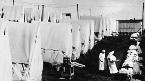 Nurses In Lawrence, Massachusetts care for victims of the flu during an outdoor fresh air cure in 1918.