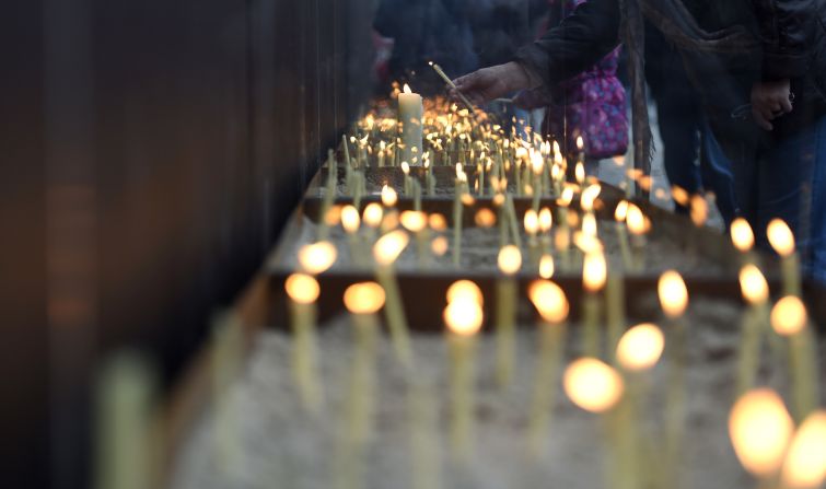 People light candles at the National Memorial for the Victims of the Berlin Wall during the commemorations.