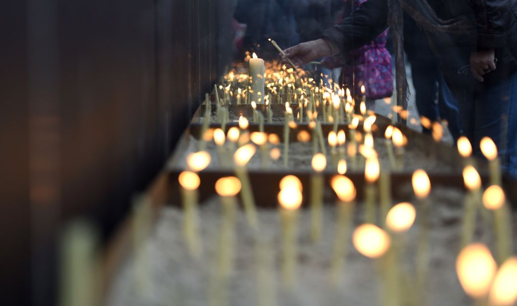 People light candles at the National Memorial for the Victims of the Berlin Wall during the commemorations.