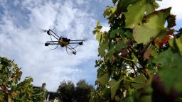 A photo taken on September 9, 2014 shows a drone flying over vineyards of the Pape Clement castle, belonging to Bordeaux winemaker Bernard Magrez in the soutwestern French town of Pessac. Magrez is the first winemaker to have bought last February a drone equipped with a infrared camera to determine the optimal maturity of the domain's grapes and thus harvest them at different times. AFP PHOTO JEAN PIERRE MULLER. (Photo credit should read JEAN PIERRE MULLER/AFP/Getty Images)