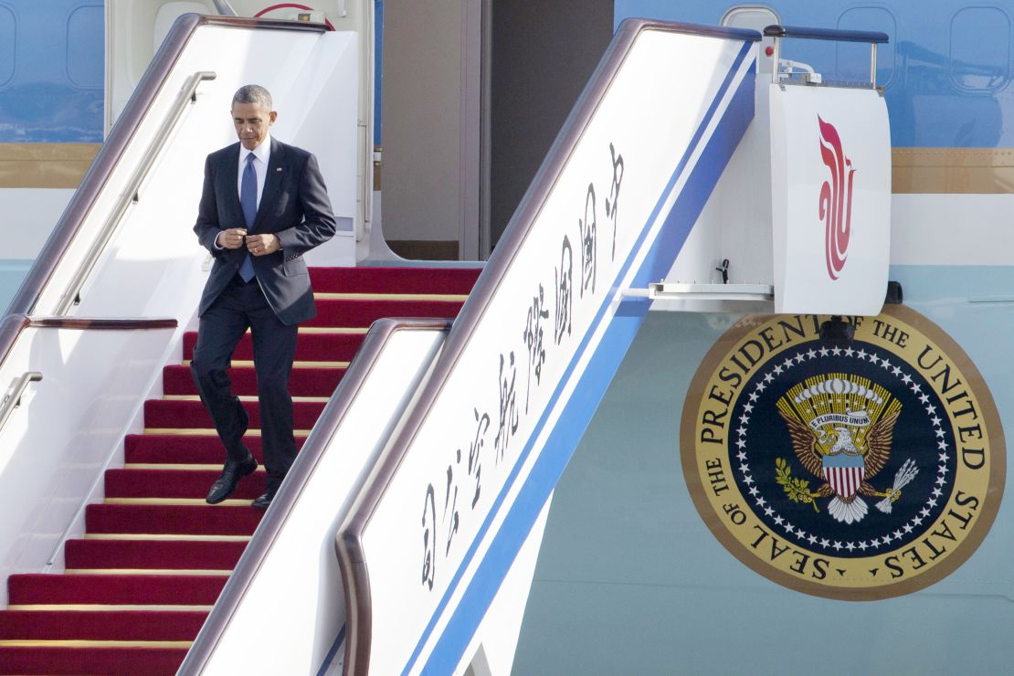 U.S. President Barack Obama steps off Air Force One as he arrives to attend the Asia-Pacific Economic Cooperation (APEC) Summit in Beijing, Monday, Nov. 10, 2014.