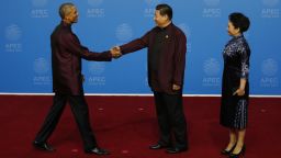 U.S. President Barack Obama, left, is greeted by Chinese President Xi Jinping and his wife, Peng Liyuan, for the dinner hosted by Xi for APEC leaders at the Beijing National Aquatics Center in Beijing, Monday, Nov. 10, 2014. (AP Photo/Ng Han Guan)