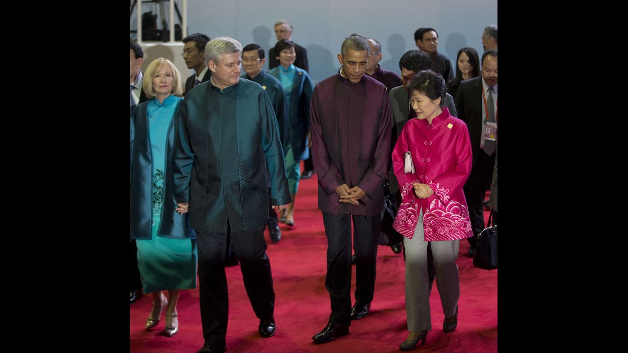 U.S. President Barack Obama, second right, walks with South Korean President Park Geun-hye, right, and Canadian Prime Minister Stephen Harper, second left, and his wife, Laureen, at the Asia-Pacific Economic Cooperation (APEC) Summit family photo, Monday, Nov. 10, 2014 in Beijing. (AP Photo/Pablo Martinez Monsivais)