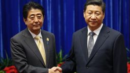 China's President Xi Jinping (R) shakes hands with Japan's Prime Minister Shinzo Abe, during their meeting on the sidelines of the Asia Pacific Economic Cooperation (APEC) meetings on November 10 in Beijing, China.