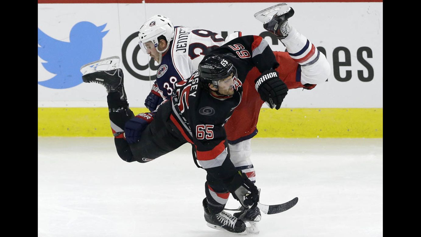Ron Hainsey of the Carolina Hurricanes and Boone Jenner of the Columbus Blue Jackets collide during their game in Raleigh, North Carolina, on Friday, November 7. Carolina won 3-2 in overtime.