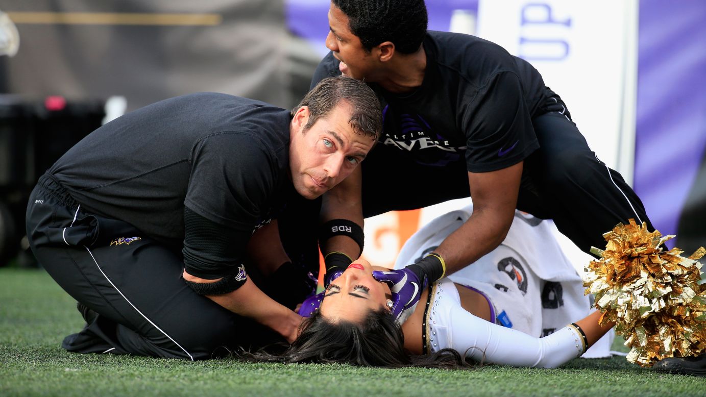 A Baltimore Ravens cheerleader is tended to after falling during a game against the Tennessee Titans at M&T Bank Stadium in Baltimore, Maryland, on Sunday, November 9.