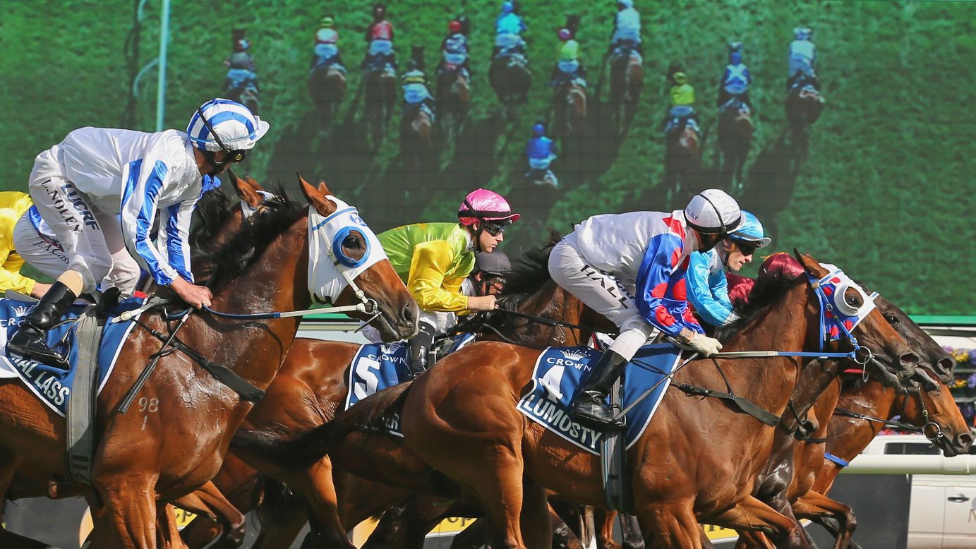Horses race out of the gates during the 2014 Crown Oaks at Flemington Racecourse in Melbourne, Australia, on Thursday, November 6. The race was won by Hugh Bowman riding Set Square.