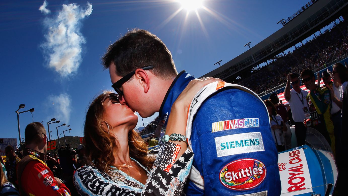 Kyle Busch kisses his wife, Samantha, prior to the start of the NASCAR Sprint Cup Series Quicken Loans Race for Heroes 500 at the Phoenix International Raceway in Avondale, Arizona, on Sunday, November 9.