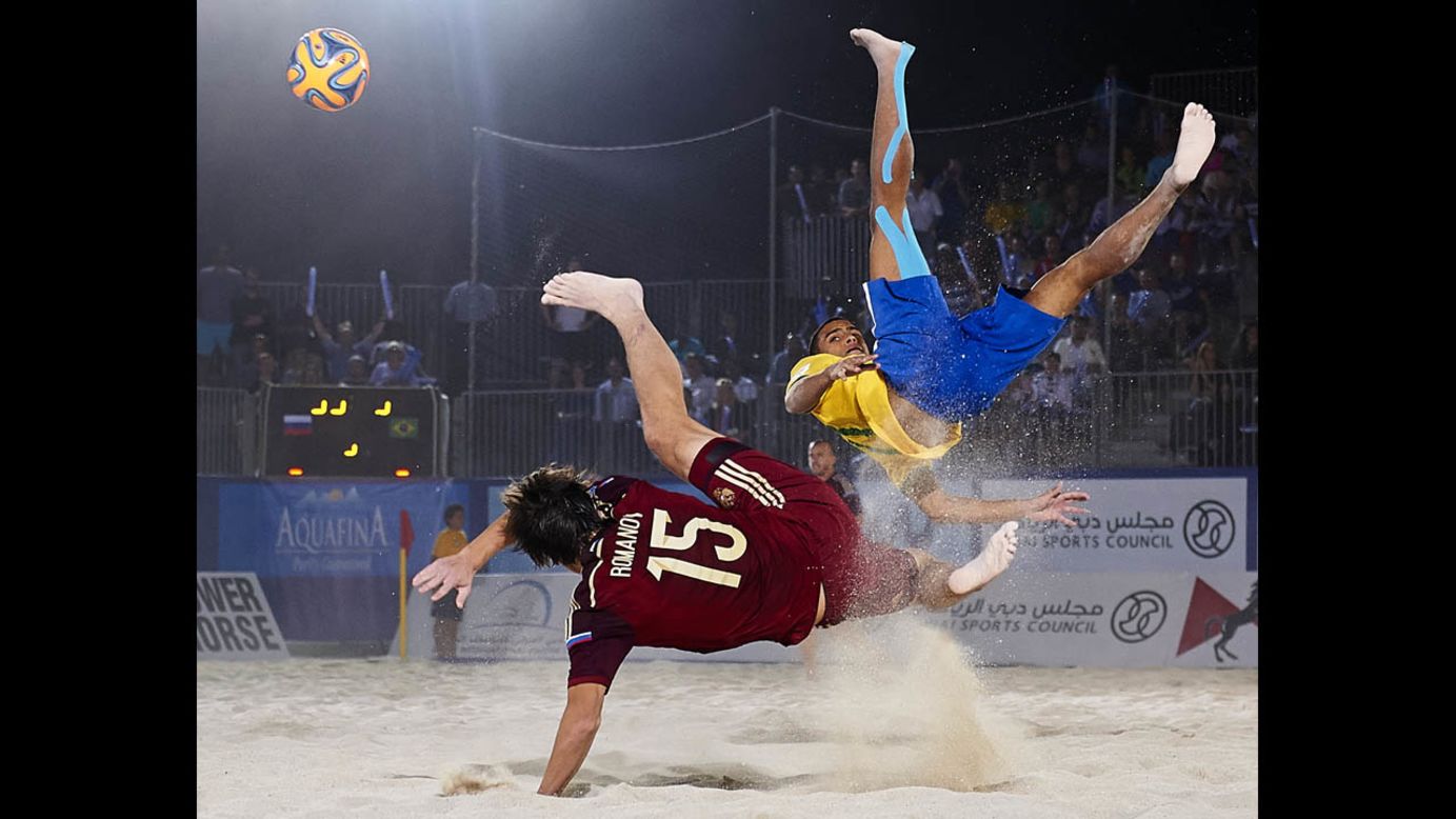 Rodrigo da Costa of Brazil, right, competes for the ball with Kirill Romanov of Russia during the 2014 Beach Soccer Intercontinental Cup final match in Dubai on Saturday, November 8. Brazil defeated Russia 3-2 in extra time.