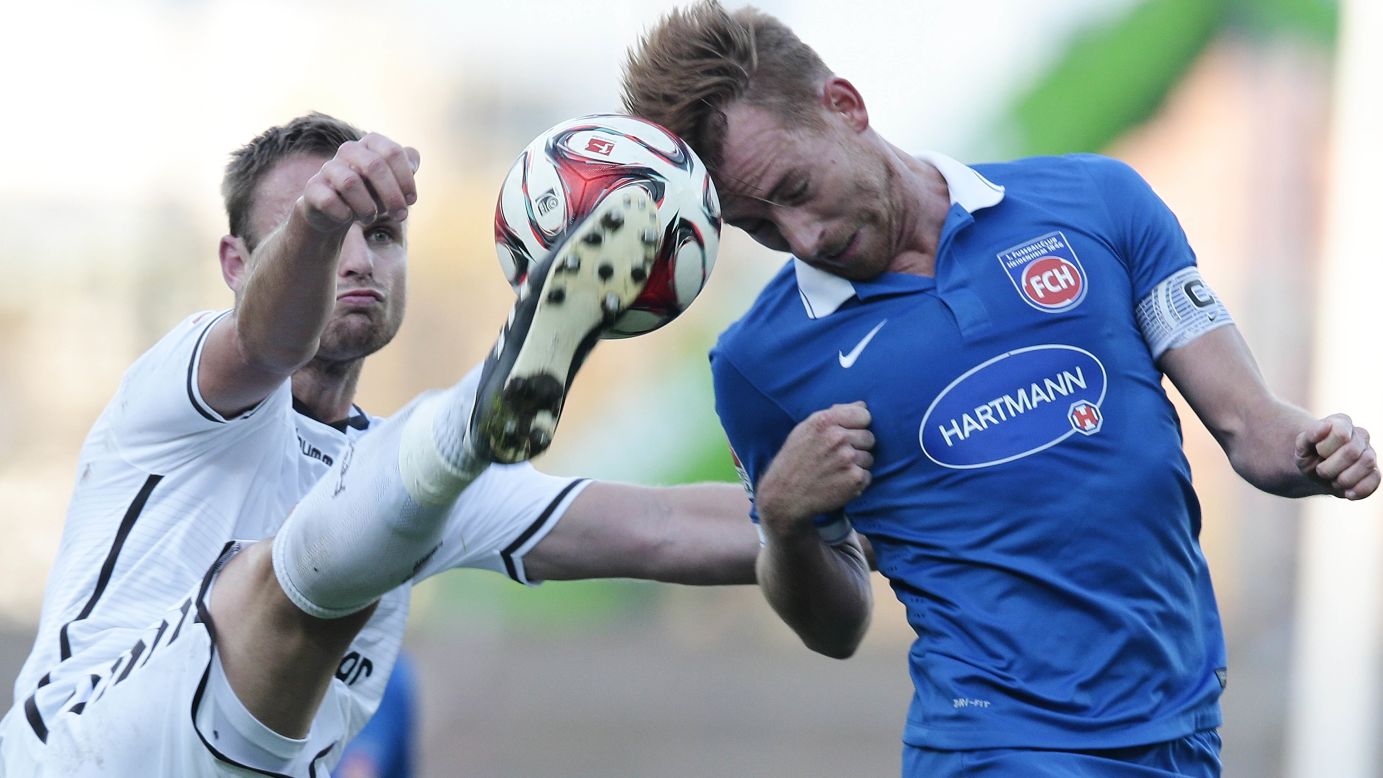 Bernd Nehrig of FC St. Pauli, left, and Marc Schnatterer of 1. FC Heidenheim compete for the ball during the Second Bundesliga match on Saturday, November 8, at Millerntor Stadium in Hamburg, Germany.