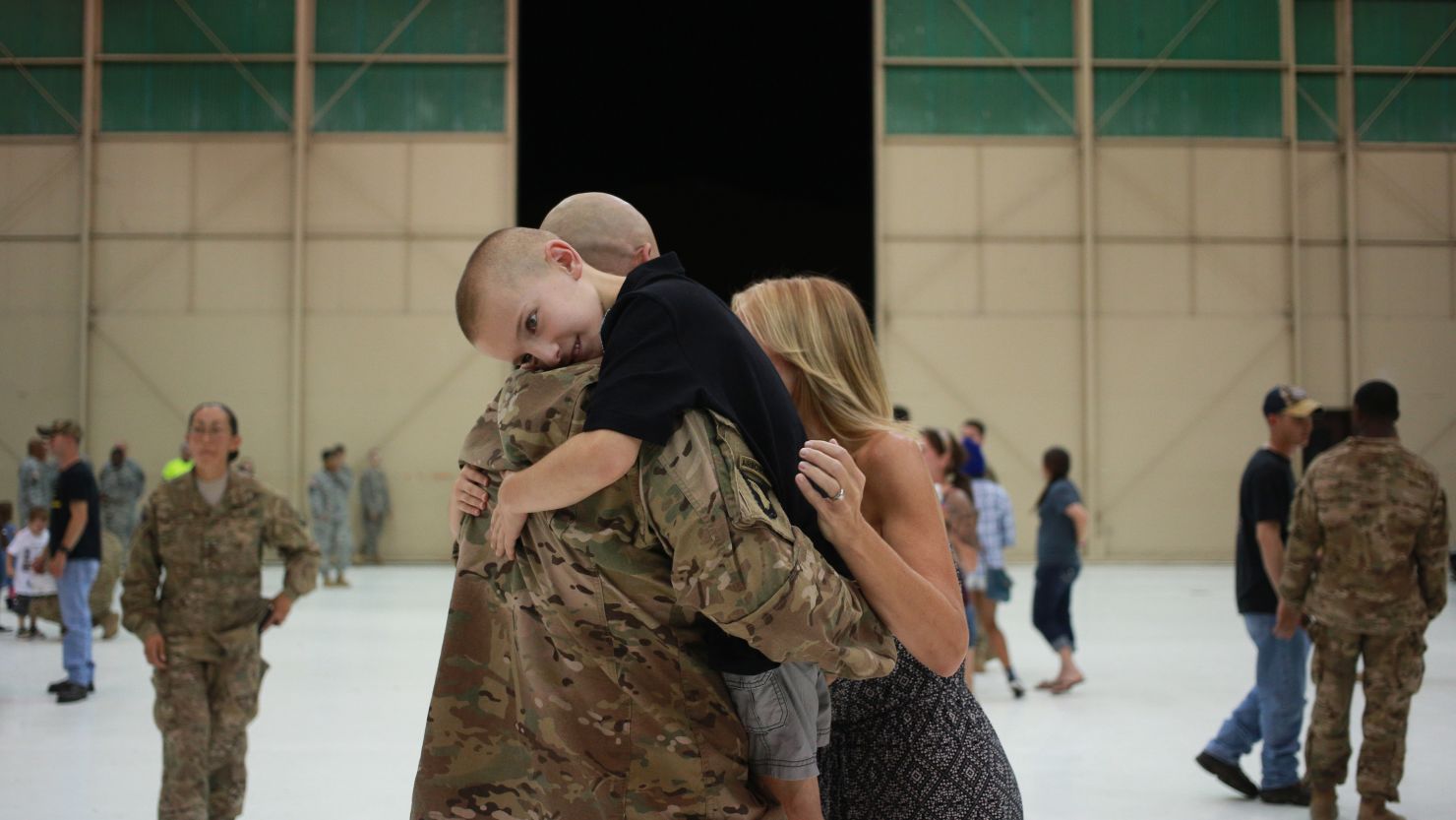 Bradyn Vest hugs his dad, Sgt. 1st Class Kevin Vest, after a homecoming ceremony September 1 in Fort Campbell, Kentucky.  