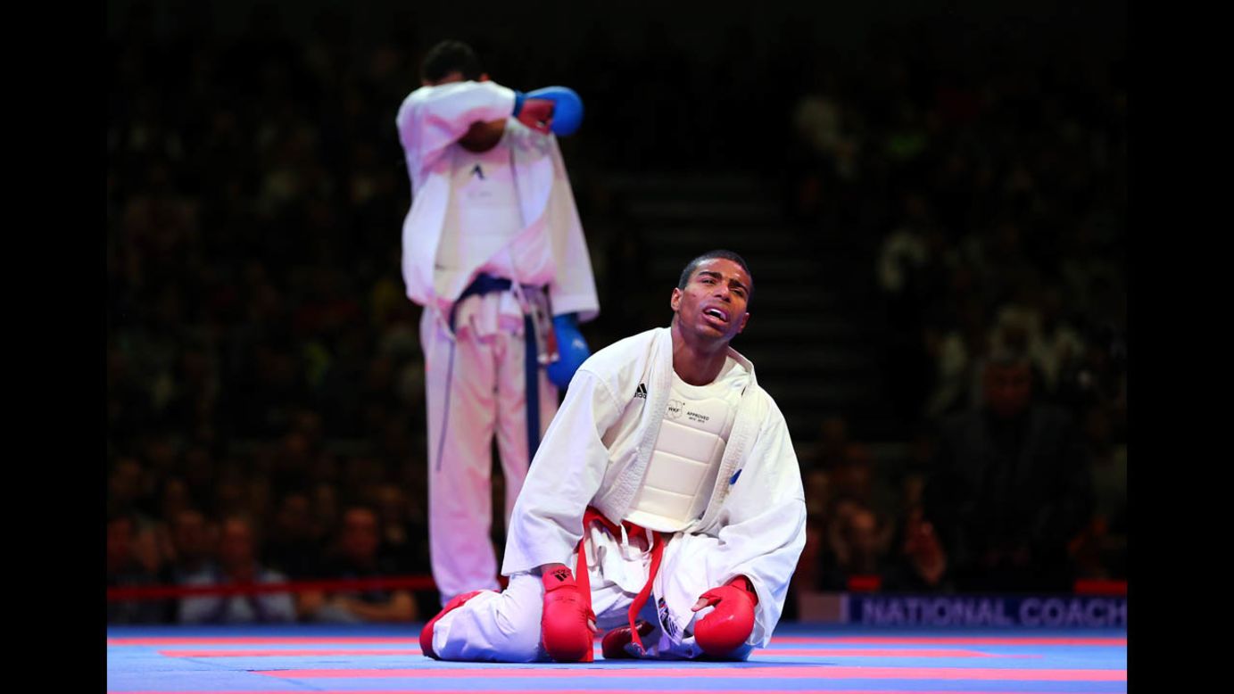 William Rolle of France celebrates on his knees after defeating Magdy Hanafy of Egypt during their men's gold medal bout in the Karate World Championships at OVB-Arena in Bremen, Germany, on Saturday, November 8.