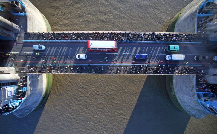 The new glass floor at the Tower Bridge spans 11 meters long between the north and south towers. London's red buses and black cabs can be seen from 42 meters above the River Thames.